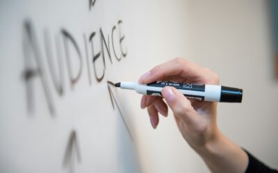 personne tenant un stylo à clic blanc et bleu