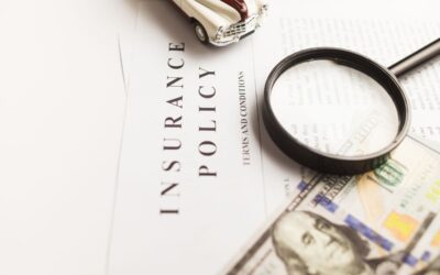 Assurance policy, magnifying glass, toy car, dollar bills, document review
